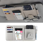 A black PU leather car visor organizer with a central zipper and visible mesh pockets for small item storage.