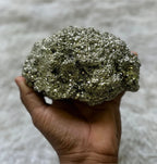 A natural BharatYug pyrite stone mineral specimen piece on a plain background