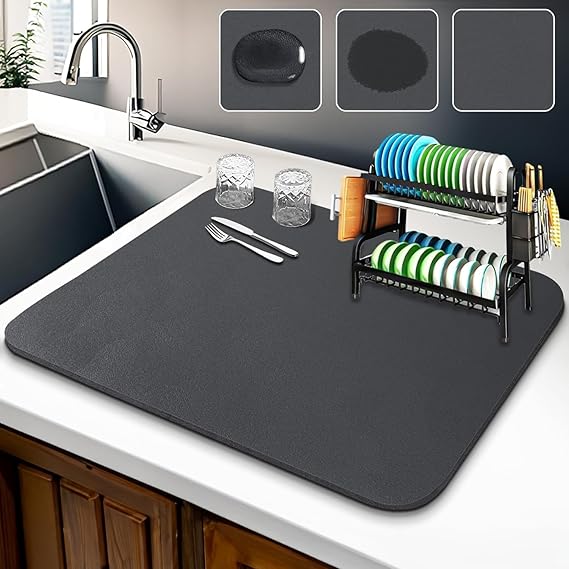A set of two flexible absorbent kitchen drying mats on a granite countertop
