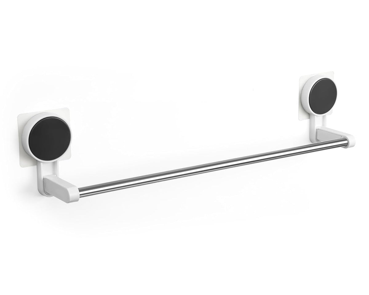 A close-up of a silver-toned self-adhesive single rod mounted on a white tile wall.