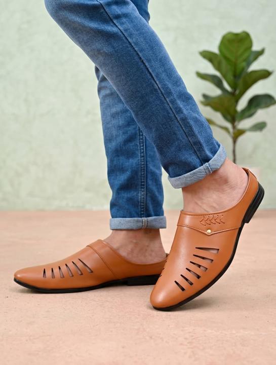 A pair of tan men's slip-on loafers with a cut-out pattern on the upper