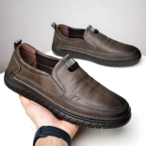 A pair of polished slip-on walkers with a black synthetic finish and elastic side gussets