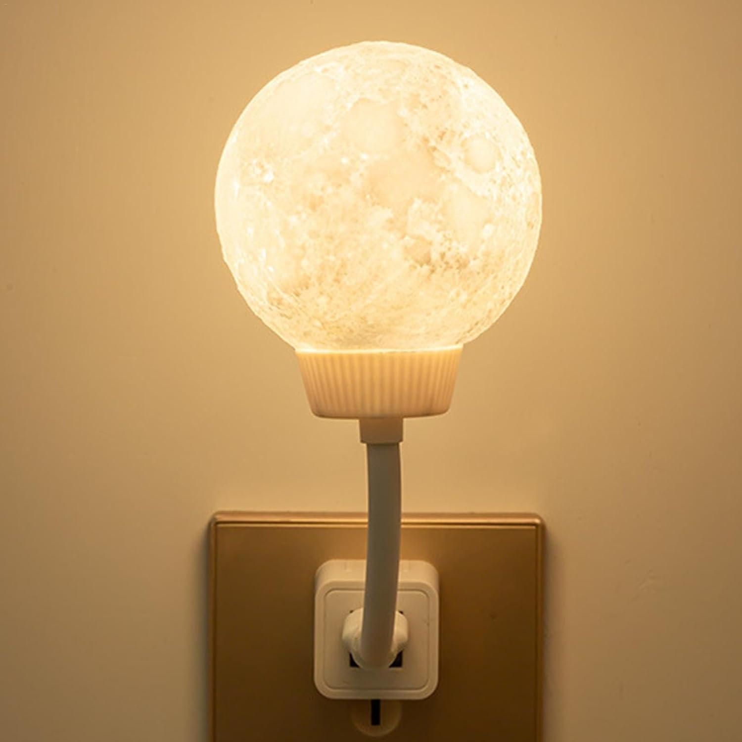 A moon-shaped decorative LED light sitting on a bedroom table