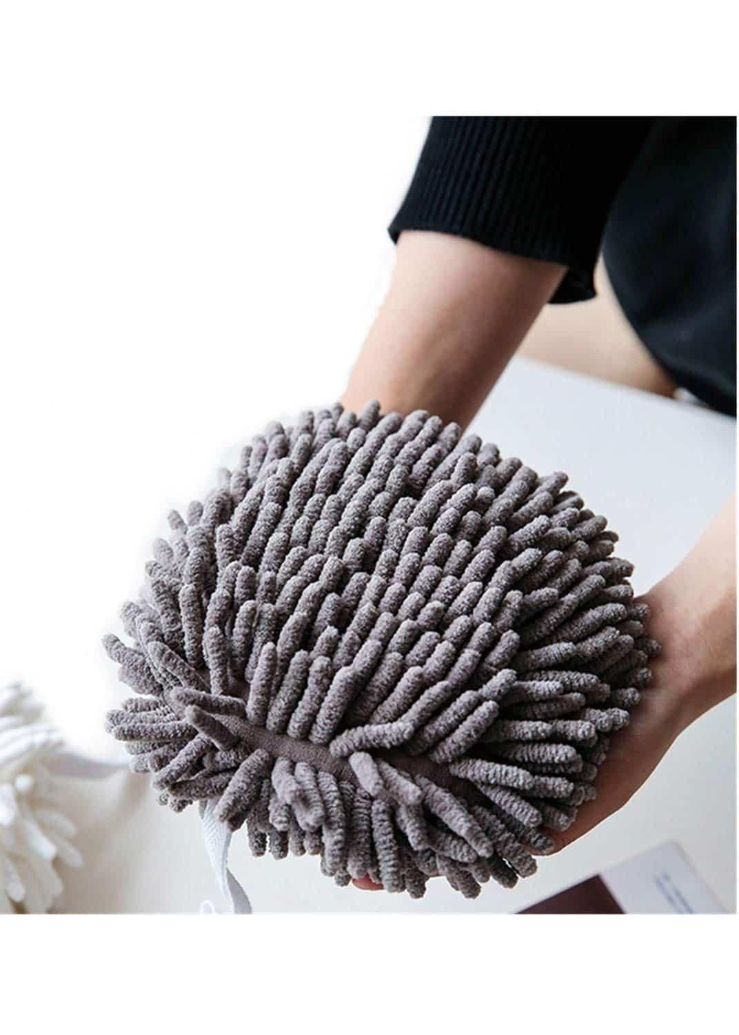 A fuzzy ball shaped hand towel designed for kitchen and bathroom use