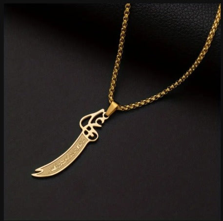Close up of an Ali Sword design pendant made from stainless steel on a matching chain