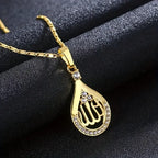 A silver-toned Allah pendant with diamond accents on a matching copper chain