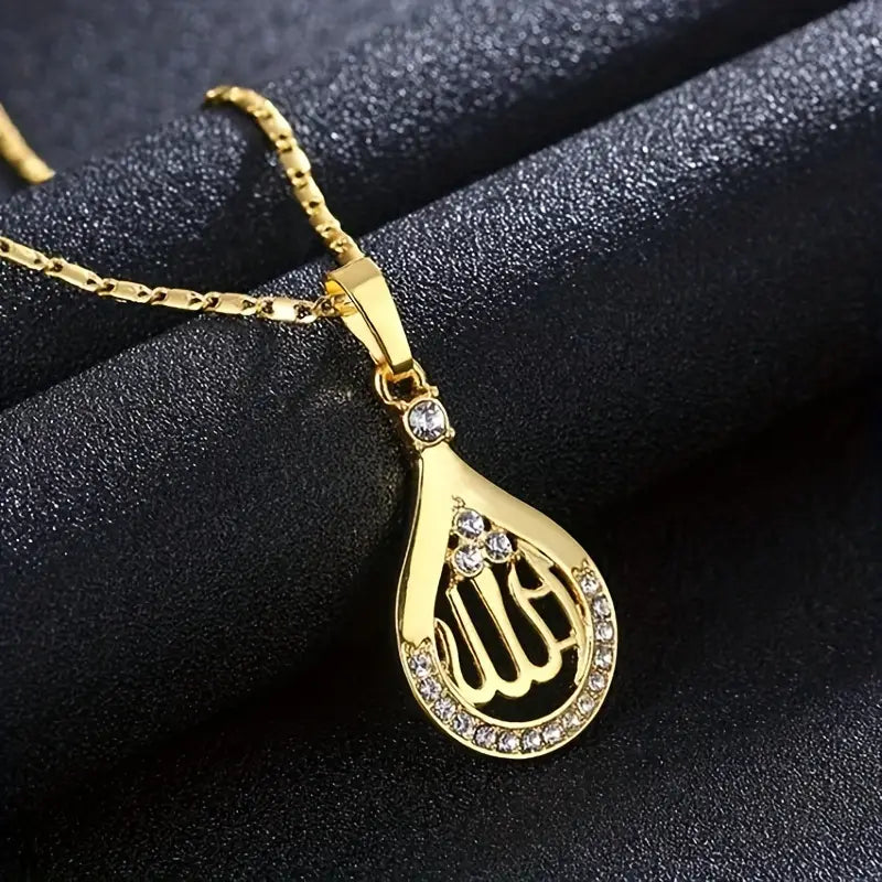 A silver-toned Allah pendant with diamond accents on a matching copper chain