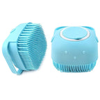 A soft silicone bath brush with an integrated hanging hook for shower use.