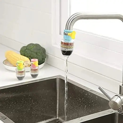 A plastic home kitchen water filter attached to a standard silver faucet.