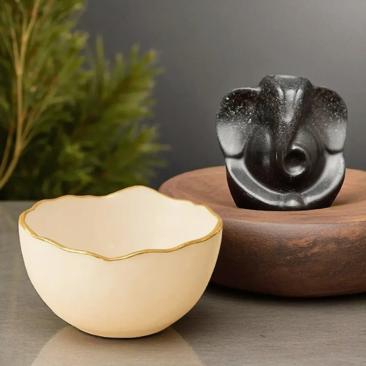 A decorative stone bowl with a sculpted Ganesh idol for desk storage