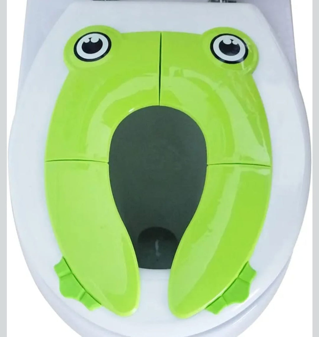 A white plastic portable potty seat for toddlers used for travel.