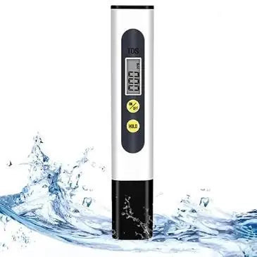 Digital water TDS meter tester held in hand showing water quality results on a small LCD screen