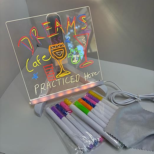 Transparent acrylic writing board resting on a wooden desk surface