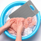 A handheld plastic laundry washing board with textured ridges for scrubbing clothes
