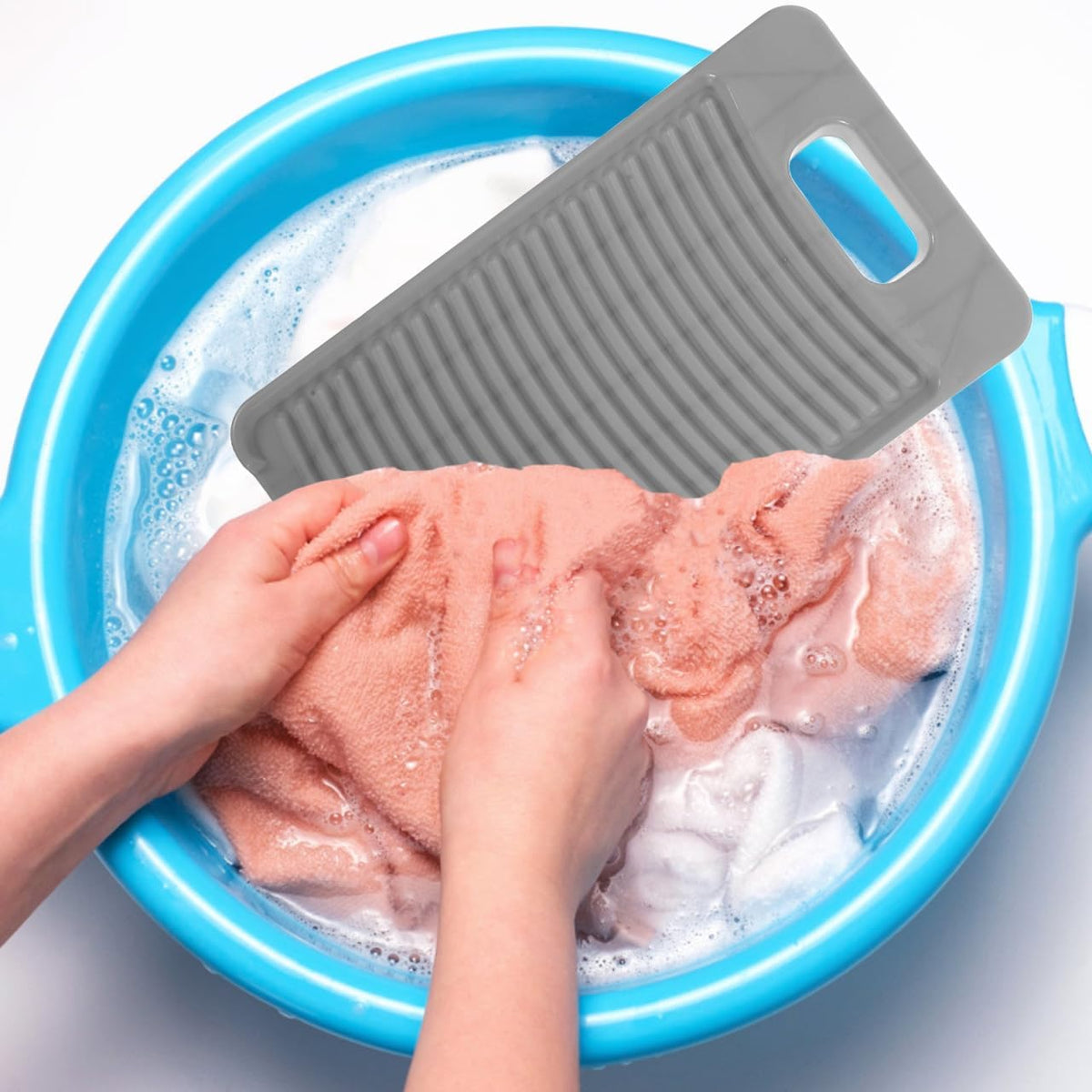 A handheld plastic laundry washing board with textured ridges for scrubbing clothes