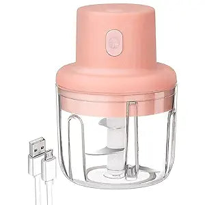 A compact mini electric chopper with a white plastic body and clear container.