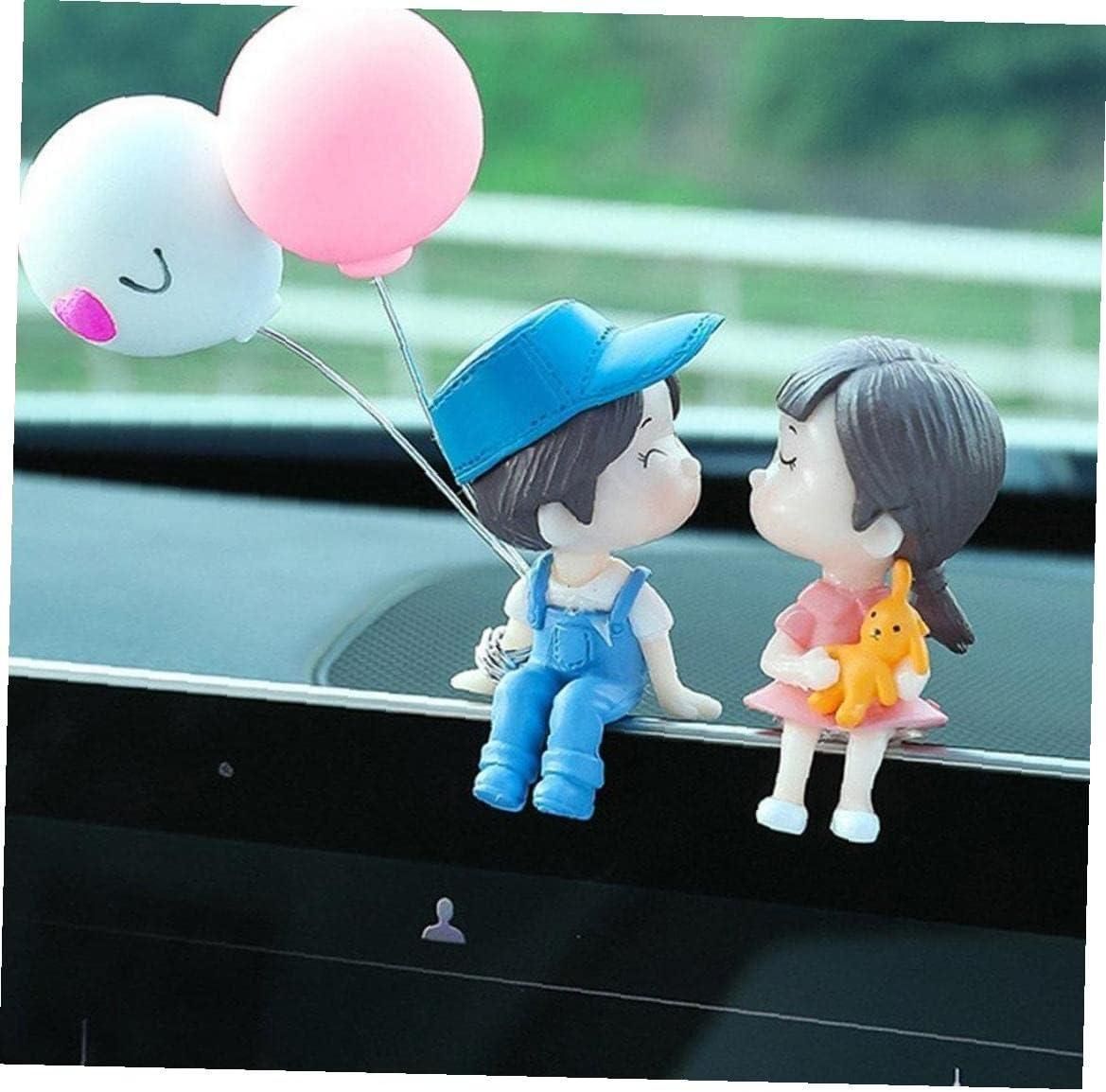 A decorative cartoon couple figurine for car dashboard display