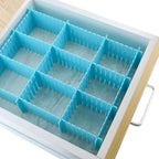 A set of 8 adjustable plastic drawer organiser dividers in assorted colours