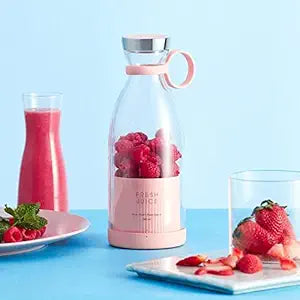 A portable travel juice blender made of plastic with a blending container and lid.