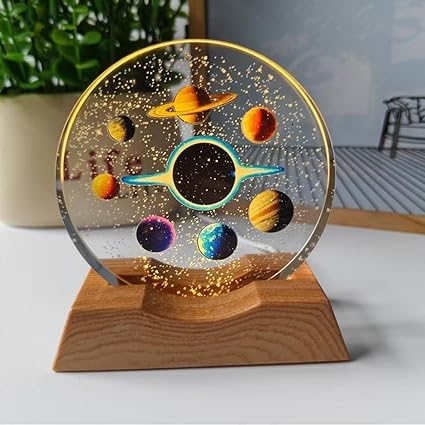 A clear glass cube featuring a laser-etched 3D space theme design