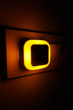 A small plug-in smart LED night lamp for bedroom or hallway use