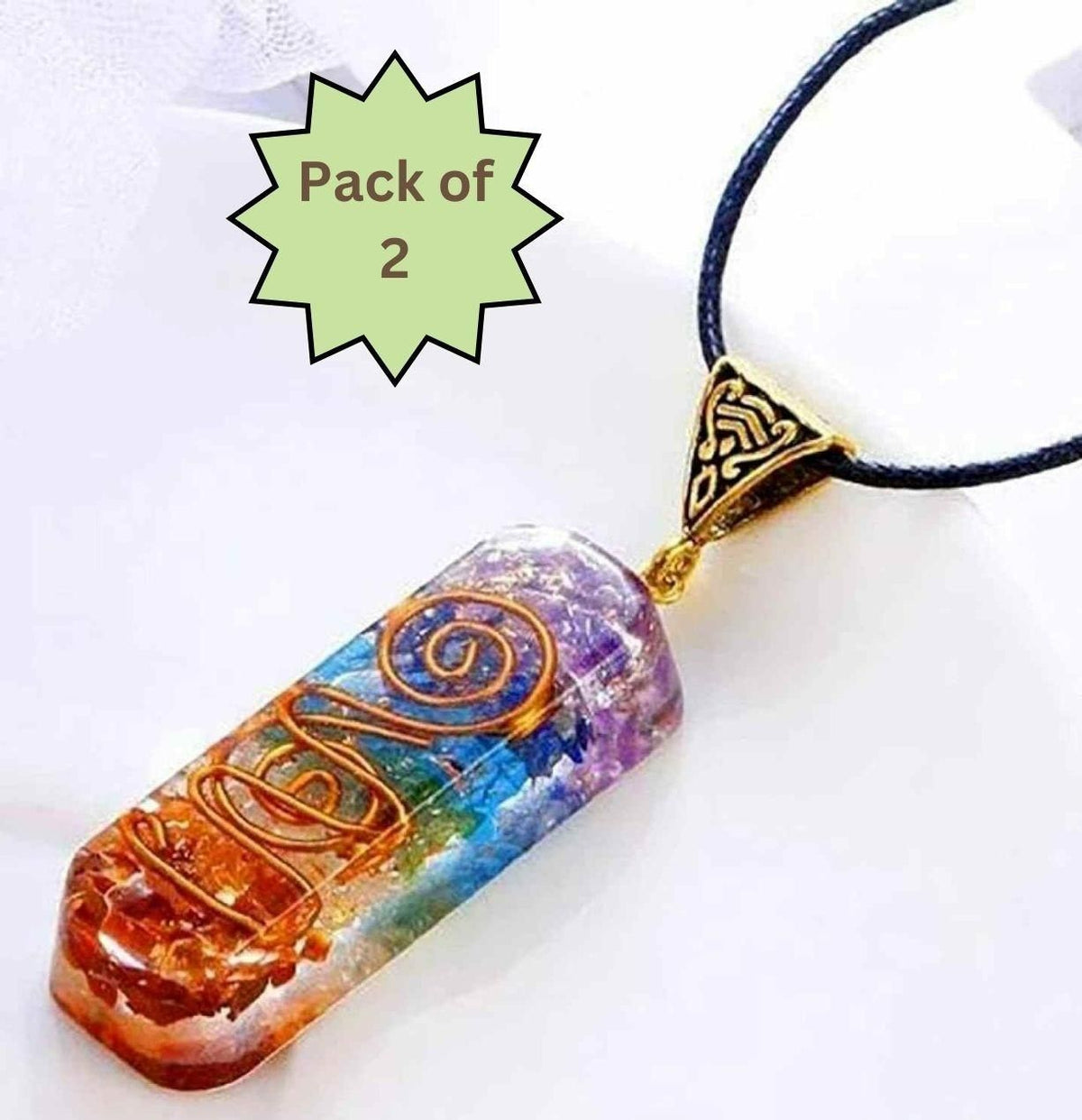 Two titanium-coated quartz stone pendants on a neutral surface