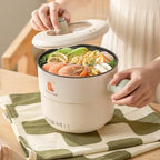 Electric mini cooking pot with 1.5L capacity and non-stick interior