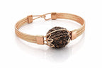 A handmade 5 Mukhi Rudraksha bracelet in a copper frame on a white background
