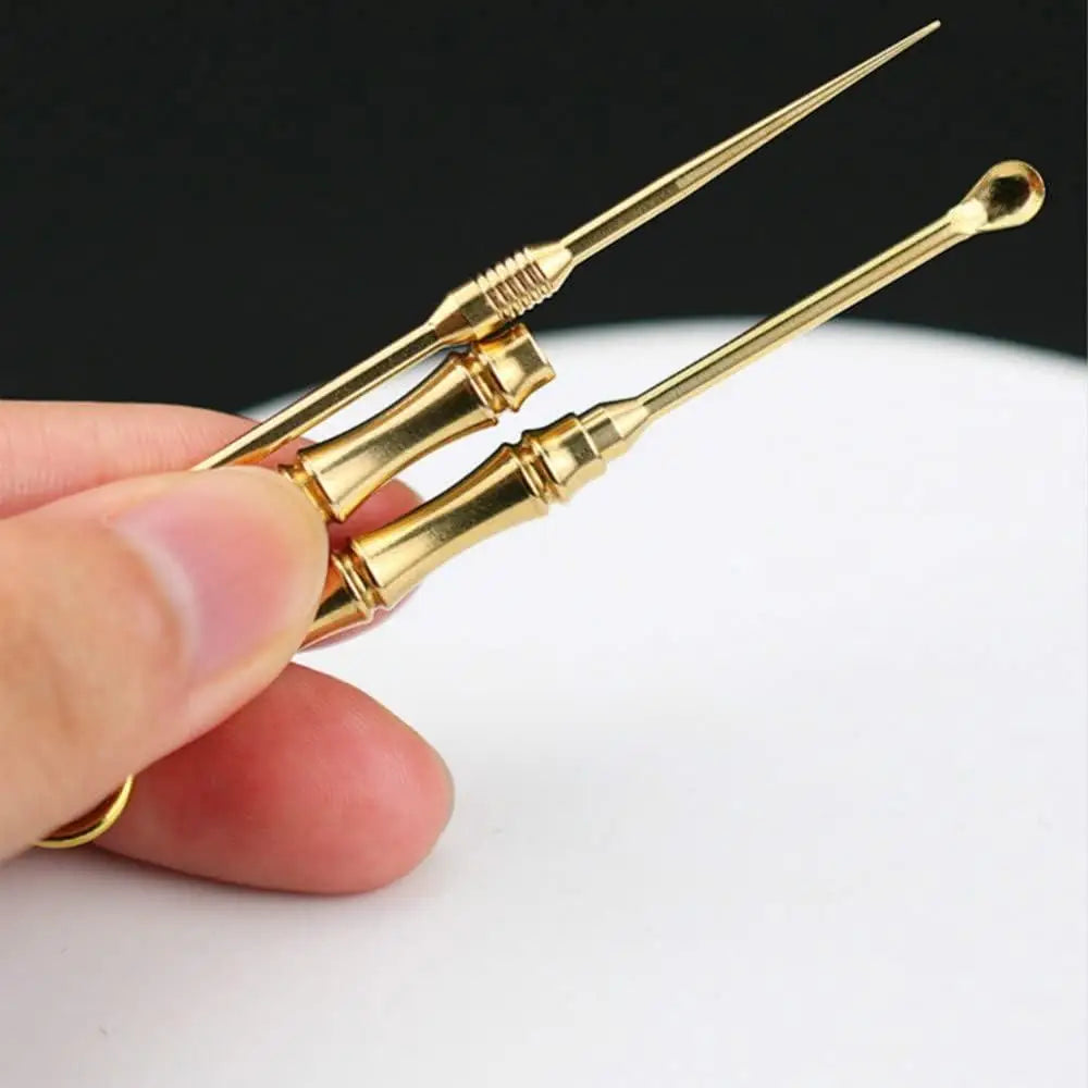 A single titanium toothpick for oral hygiene held against a plain background.