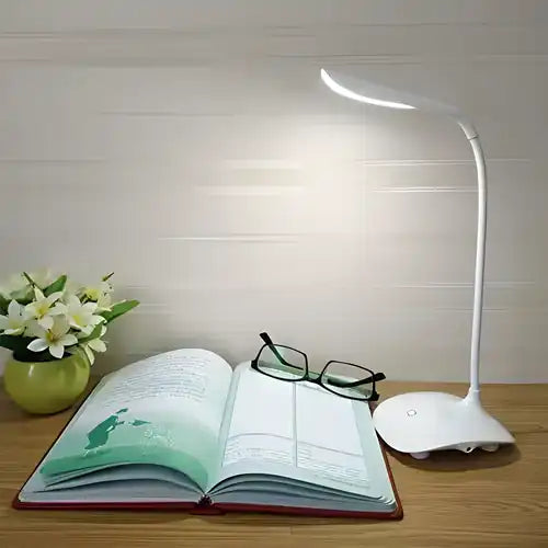 A white portable table lamp with a flat base and a touch-sensitive LED switch.
