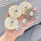 Five petal-shaped adhesive wall hooks arranged on a white background.